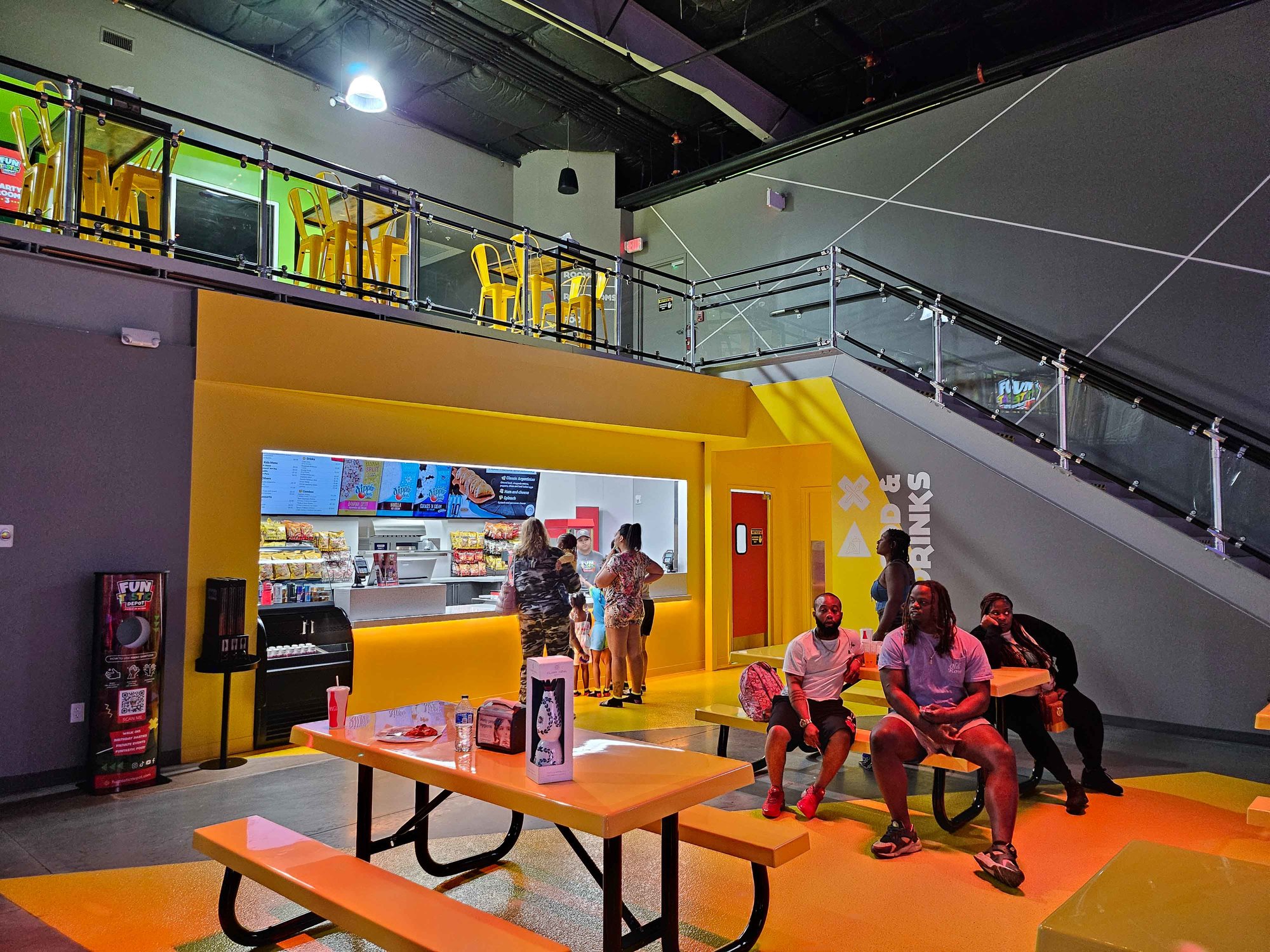 yellow corner with food ordering counter and tables